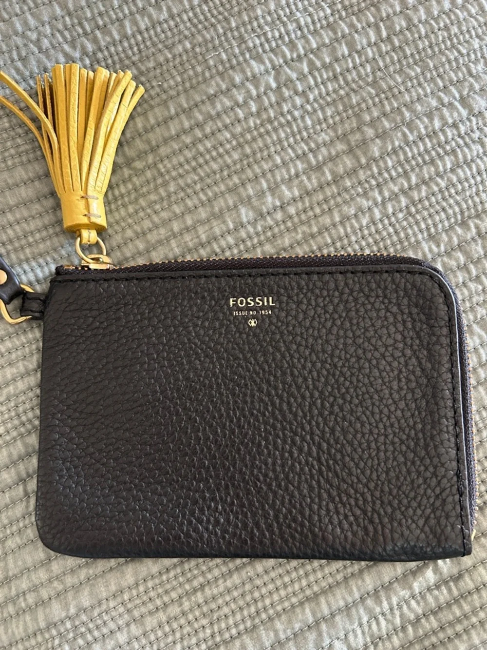 Fossil Tara Black Pebbled Leather Wristlet with Yellow Tassel Accent